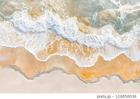 Aerial View of Ocean Waves Crashing on Sandy Beach 128850036