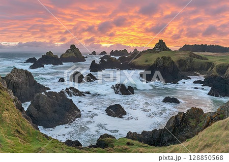 Dramatic Coastal Sunset Over Rocky Shore 128850568