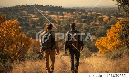 Two Backpackers on a Golden Trail, Autumnal Vista, Back View, Ad 128850685