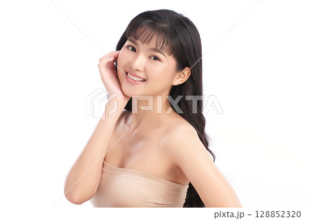 A beautiful young Asian woman with clean, fresh skin against a white background. Skincare, facial treatment, cosmetology, beauty, and spa. An elegant portrait of an Asian woman. 128852320