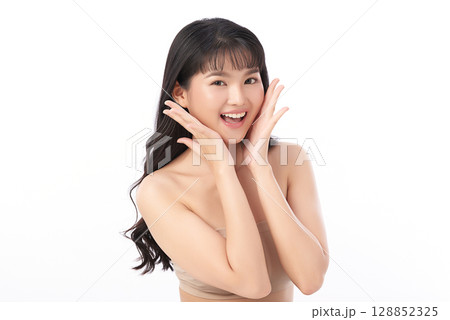 A beautiful young Asian woman with clean, fresh skin against a white background. Skincare, facial treatment, cosmetology, beauty, and spa. An elegant portrait of an Asian woman. A beautiful young Asian woman with clean, fresh skin against a white background. Skincare, facial treatment, cosmetology, beauty, and spa. An elegant portrait of an Asian woman. 128852325