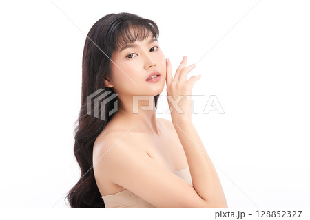 A beautiful young Asian woman with clean, fresh skin against a white background. Skincare, facial treatment, cosmetology, beauty, and spa. An elegant portrait of an Asian woman. 128852327
