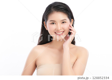 A beautiful young Asian woman with clean, fresh skin against a white background. Skincare, facial treatment, cosmetology, beauty, and spa. An elegant portrait of an Asian woman. 128852334