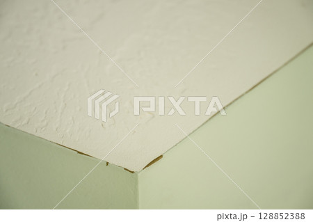 Missed corner section where old paint is visible through the new coat overlap.  128852388