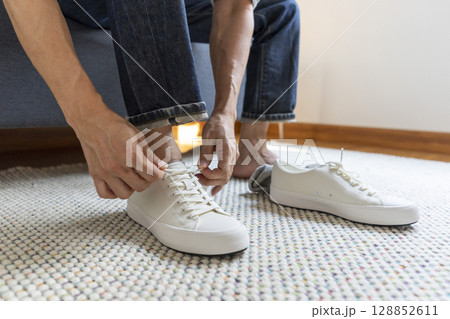 Young man dress shoes at home 128852611