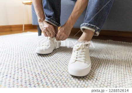 Young man dress shoes at home 128852614