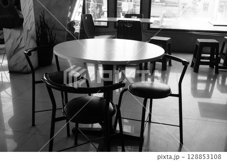 Black and White Interior of a Cafe with a Round Table 128853108