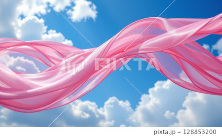 Pink silk fabric flowing in bright blue sky with soft white clouds, creating light and airy feeling 128853200