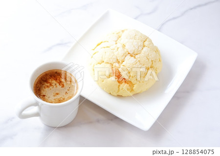 メロンパンとコーヒー - おいしそうなメロンパンと、淹れたてのコーヒーで、おやつの時間 メロンパンとコーヒー - おいしそうなメロンパンと、淹れたてのコーヒーで、おやつの時間 128854075