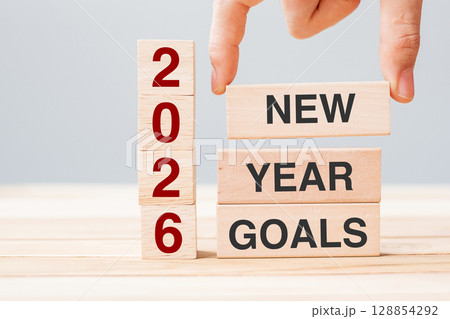 hand holding wooden block with text 2026 NEW YEAR NEW GOALS on table background. Resolution, strategy, solution, business and holiday concepts hand holding wooden block with text 2026 NEW YEAR NEW GOALS on table background. Resolution, strategy, solution, business and holiday concepts 128854292