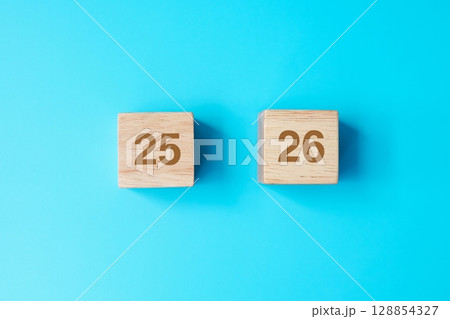 wooden cube block with 2026 text on blue background. Resolution, plan, review, goal, start and New Year holiday concepts wooden cube block with 2026 text on blue background. Resolution, plan, review, goal, start and New Year holiday concepts 128854327