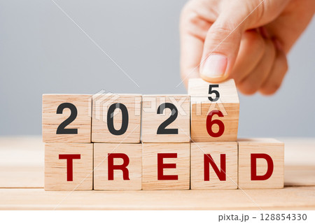 hand flipping block 2025 to 2026 TREND text on table. Resolution, idea, goal, motivation, reboot, business and New Year holiday concepts hand flipping block 2025 to 2026 TREND text on table. Resolution, idea, goal, motivation, reboot, business and New Year holiday concepts 128854330