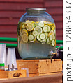 Fresh Citrus and Cucumber Infused Water in a Clear Drink Dispenser 128854337