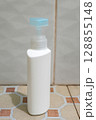 Minimalist White Cosmetic Pump Bottle on Tile Floor Minimalist White Cosmetic Pump Bottle on Tile Floor 128855148
