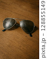 Classic Aviator Sunglasses on Wooden Table Classic Aviator Sunglasses on Wooden Table 128855149