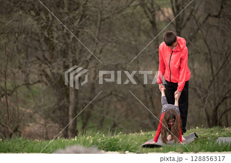 Joyful childhood moments captured in a playful outdoor environment during spring with friends engaging in fun activities and laughter amidst nature's beauty Joyful childhood moments captured in a playful outdoor environment during spring with friends engaging in fun activities and laughter amidst nature's beauty 128856317