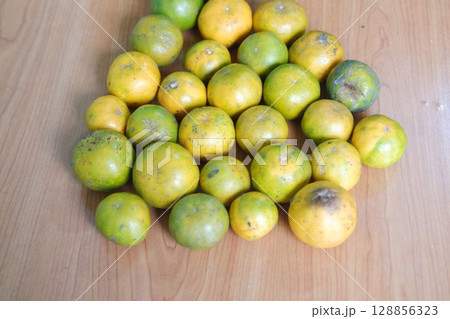 Group of Fresh Oranges on Wooden Table 128856323