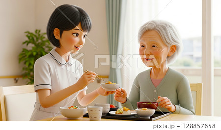 食事介助をする介護士と高齢者の女性 128857658