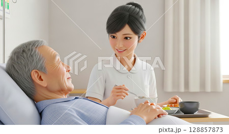食事介助をする介護士と高齢者の男性 128857873