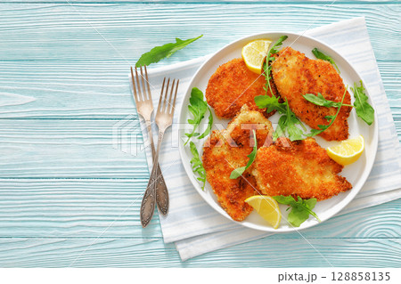 crispy parmesan crusted chicken cutlets, top view crispy parmesan crusted chicken cutlets, top view 128858135