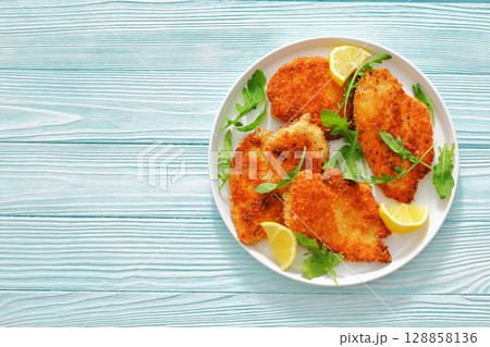 crispy parmesan crusted chicken cutlets, top view crispy parmesan crusted chicken cutlets, top view 128858136