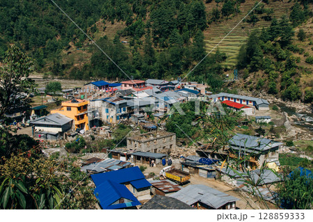 Terraced farming in Nepal. Village on a terraced hill during Annapurna Circuit Trek in Himalayas, Annapurna Conservation Area, Nepal. Rise fields. Agricultural concept 128859333