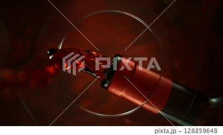 Pouring Red Wine into Glass, Macro Shot. Unique Composition Shot from Inside of the Glass. Pouring Red Wine into Glass, Macro Shot. Unique Composition Shot from Inside of the Glass. 128859648