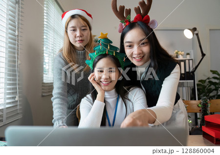 Festive Office Celebration with Colleagues in Holiday Attire Enjoying a Virtual Christmas Party 128860004