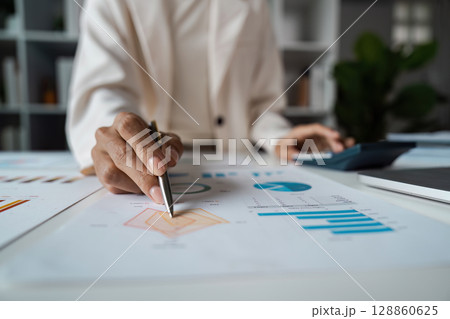 Business Professional analysis Financial Data with Graphs and Charts in Modern Office Setting Business Professional analysis Financial Data with Graphs and Charts in Modern Office Setting 128860625