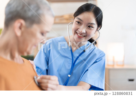Smiling Healthcare Professional Visiting Senior at Home, Providing Medical Care and Support 128860831