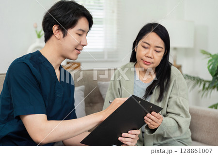 Healthcare Professional Conducting Home Visit with Patient, Providing Personalized Medical Care in a Comfortable Home Environment 128861007