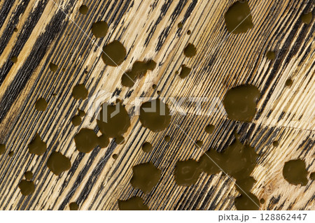 brown oil for the treatment and protection of wood by staining, linseed oil for painting wood for a beautiful appearance and protecting the tree from the sun and pests 128862447