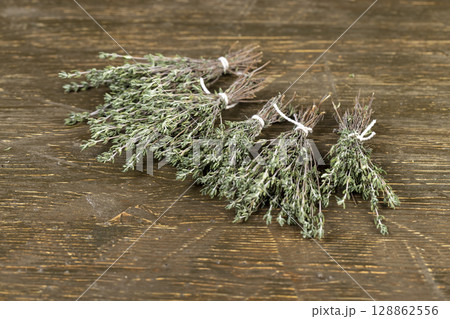 green thyme for use in cooking and folk medicine, thyme spices lying on a wooden table during drying 128862556