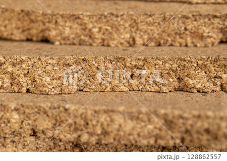 material that is obtained from the bark of a cork tree, closeup, side view material that is obtained from the bark of a cork tree, closeup, side view 128862557