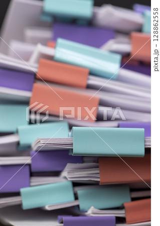sheets of paper for documents are joined together, the sheets of paper is different in each clip, side view 128862558