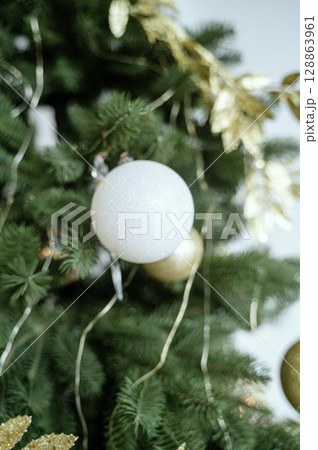 A Christmas ball decorates the tree. A Christmas ball decorates the tree. 128863961