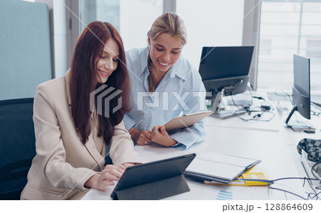 Engaging in a Collaborative Business Meeting Using Tablets in a Modern Office Environment Engaging in a Collaborative Business Meeting Using Tablets in a Modern Office Environment 128864609