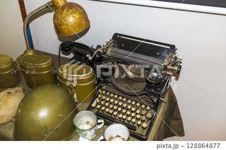 Second world war items belonged to the soviet soldiers on display of the museum. Vintage typewriter next to them Second world war items belonged to the soviet soldiers on display of the museum. Vintage typewriter next to them 128864877