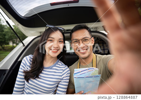 Couple capturing joyful moment during road trip selfie 128864887