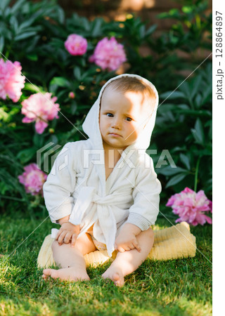 Curious Baby Among Greenery And Flowers Curious Baby Among Greenery And Flowers 128864897