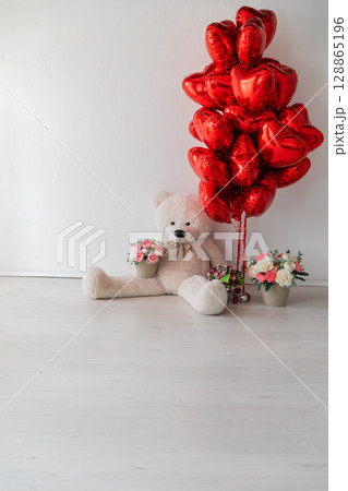 teddy bear and red balloons in the interior 128865196
