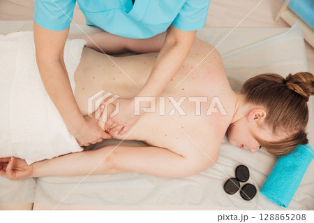 Woman Massage Therapist Doing Medical Back Massage To Woman 128865208