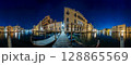 Venice Grand Canal at night with historic buildings, gondolas, and reflections under a starry sky. 128865569
