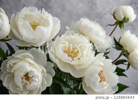 A stunning display of white peonies fills the frame, revealing delicate petals and vibrant green leaves. This arrangement captures the essence of spring's beauty and freshness Generative AI 128865643