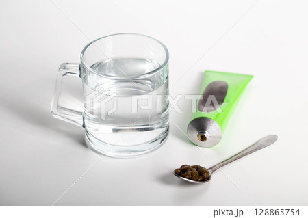 Tube with medicinal paste on herbs used in urology. Treatment of infectious inflammatory diseases of the urinary tract, close-up 128865754