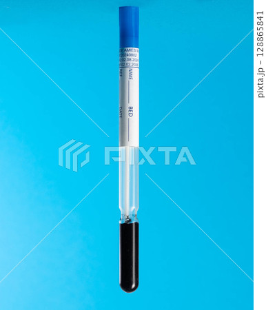 Sterile test tube with urological and gynecological probe on a blue background, isolate, close-up. Diagnosis of infections and bacteria, antibodies Sterile test tube with urological and gynecological probe on a blue background, isolate, close-up. Diagnosis of infections and bacteria, antibodies 128865841