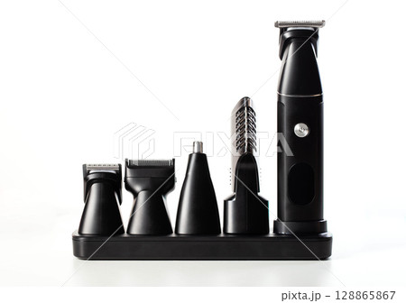 Set of modern electric trimmer with attachments for beard, ears and nose on a white background, isolate, close-up 128865867