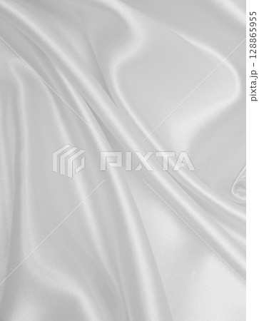 Smooth elegant white silk or satin luxury cloth texture as wedding background. Luxurious background design 128865955