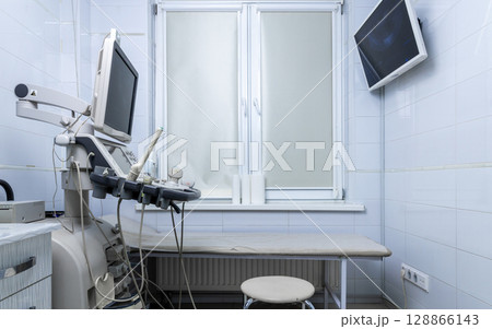 Clean and Modern Ultrasound Room Featuring Advanced Medical Equipment for Diagnostic Imaging and Patient Examination in a Bright Clinical Setting Clean and Modern Ultrasound Room Featuring Advanced Medical Equipment for Diagnostic Imaging and Patient Examination in a Bright Clinical Setting 128866143