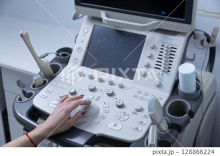 Advanced Ultrasound Machine with Various Control Buttons and a Probe Ready for Use in a Medical Environment for Diagnostic Imaging Procedures Advanced Ultrasound Machine with Various Control Buttons and a Probe Ready for Use in a Medical Environment for Diagnostic Imaging Procedures 128866224